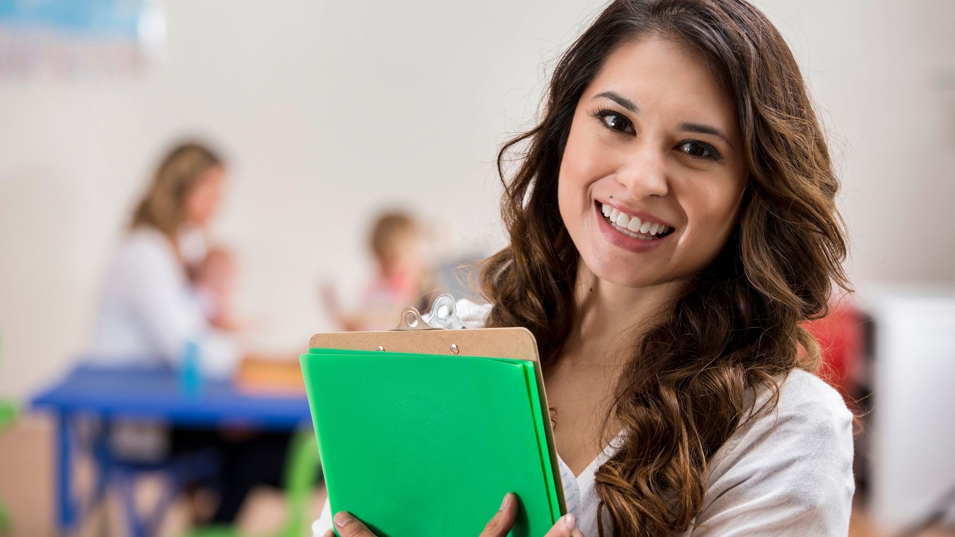 Smiling woman holding a clipboard