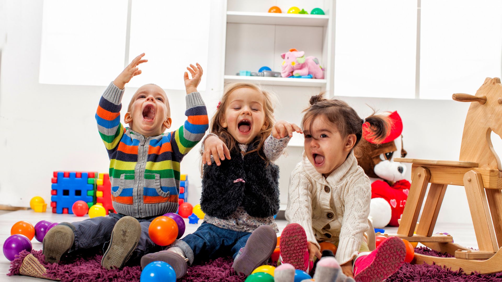 Kids playing with colorful balls indoors