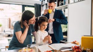 Family morning routine around kitchen table.