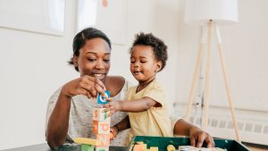 Mother and child playing with blocks.