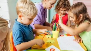 Children doing arts and crafts in classroom.