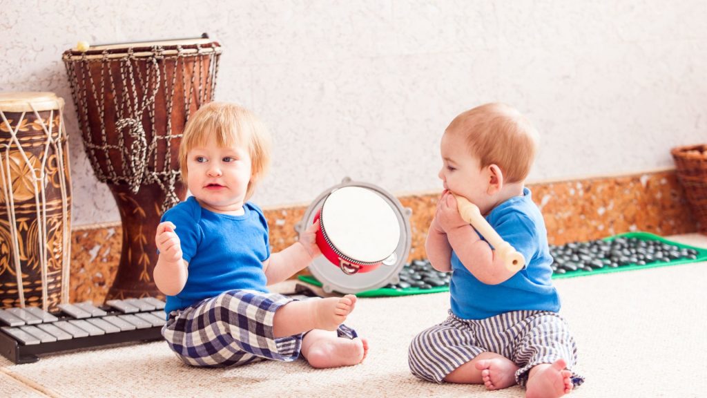 Toddlers playing with musical instruments